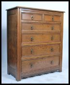A 20th century Arts and Crafts oak chest of drawers. Two short drawers over four long graduating
