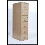 A vintage industrial 20th century metal filing cabinet of slim proportions have a series of