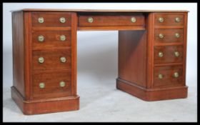 A good Victorian mahogany inverted breakfront twin pedestal desk with tooled red leather skiver, the