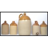 A collection of five vintage early 20th century stoneware flagons to include a very tall one with