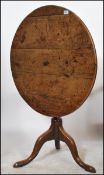 A 19th century Georgian oak tilt top table of circular form raised on tripod cabriole legs with