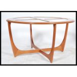 A 1970's G-Plan Atomic style coffee table of circular form raised on space age style supports with 4