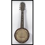An early 20th century banjo Mandolin. The circular body having 8 strings to the neck with inset