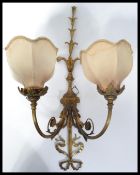 A 19th century Victorian ormolu gilt bronze twin wall sconce decorated with swags and ribbons with