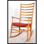 A vintage 20th century Danish Scandart rocking chair having rail back rest with shaped elbow