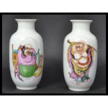 A pair of 19th century Chinese miniature vases depicting two Buddhas one in robe and one holding a