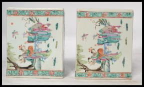 A pair of 18th century Chinese famille vert flower bricks having green borders with famille rose
