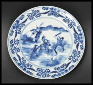 An early 19th century Chinese blue and white cabinet plate depicting fighting warriors and