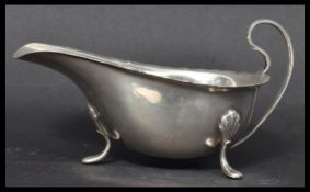 An early 20th century silver hallmarked sauce boat