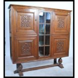 A large early 20th century carved oak bookcase cab