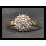 A hallmarked 18ct gold and diamond cluster ring ha