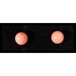 A pair of 9ct gold and coral stud earrings complet