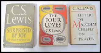 A group of three C.S. Lewis first edition hard bac