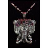A sterling silver elephant mask pendant on silver