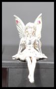 A sterling silver figurine of a fairy modeled in a