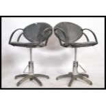 A pair of retro style barbers stools, black leathe