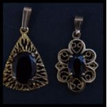 Two 9ct gold and garnet pendants. Unmarked, tests