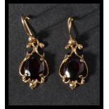 A pair of 9ct gold and amethyst earrings. Hallmark