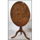 A 19th century Georgian oak tilt top table of circ