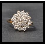 A 9ct gold and white stone cluster ring. Remnants