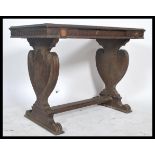 A Victorian oak writing table desk being raised on