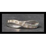 A hallmarked white gold and diamond crossover band