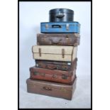 A stack of 20th century vintage suitcases / trunks