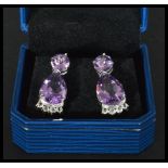 A pair of sterling silver and amethyst drop earrin