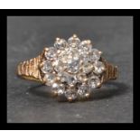 A hallmarked 9ct gold and white stone cluster ring