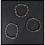 A group of three sterling silver tennis bracelets