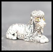 A sterling silver figurine of a poodle dog modeled