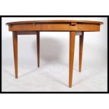 A retro 1960's teak wood extending dining table of