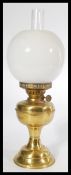 A vintage early 20th Century brass oil lamp complete with flue and milk shade fitted with a Duplex