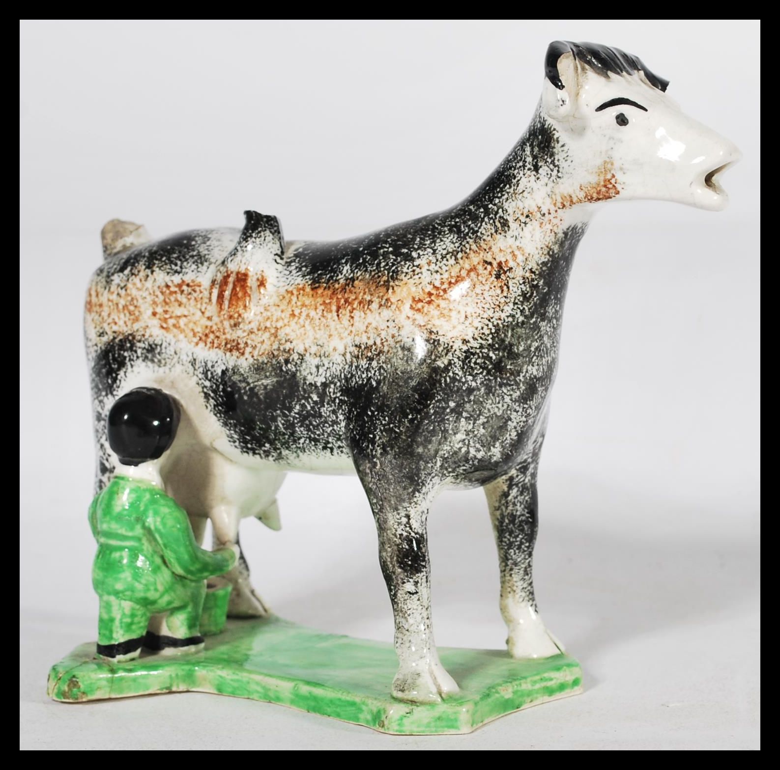 An early C19th Staffordshire pearlware cow creamer, shaped base with milk maid milking into a - Image 4 of 5