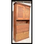 An unusual 19th century country pine estate / house keepers cupboard. Of upright form with fall