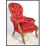 A Victorian walnut framed spoon back easy chair with carved and moulded show wood frame, scroll