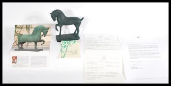 A Franklin Mint Chinese Imperial patinated bronze horse figurine signed 1985 with paperwork. Modeled