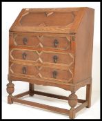 A 1930's Edwardian oak bureau, fall front with appointed interior over three graduating drawers
