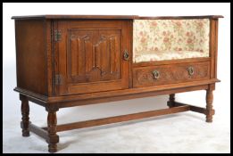 A believed Jaycee / Old Charm telephone table settle. The low wide body with arched seat recess
