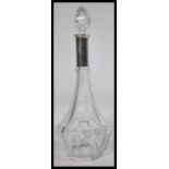 A continental silver hallmarked collared cut glass decanter having faceted glass sides with bullet
