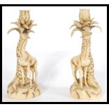 A pair of 19th Century Continental figure groups modelled as Giraffes feeding from trees. Measures