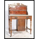 An Edwardian Art Nouveau walnut and marble tile back washstand. The white marble top over a single