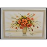 A 20th century oil on canvas painting of a vase of flowers. The vibrant colours with artist