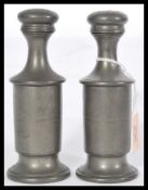 A pair of early 19th century Regency pewter writing sanders raised on stepped circular bases with
