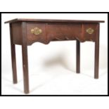 An 18th century Georgian mahogany lowboy writing table desk being raised on squared legs with fitted