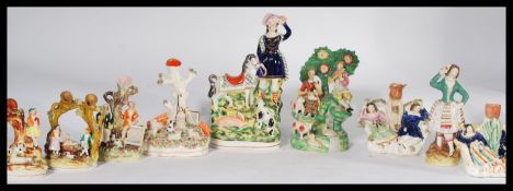 A collection of Staffordshire flat back figurines dating from the 18th century to include lady