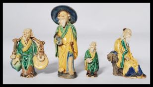 A group of four early 20th century Chinese pottery Mudman / Mudmen each in varying poses. Highest