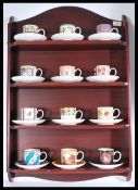 A collection of twelve Coalport ' Historic Coffee Cup Collection ' cabinet cups and saucers, each