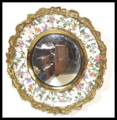 An early 20th century Burleigh Ware ceramic paint mirror having ormolu surround hand painted with