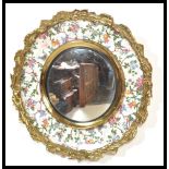 An early 20th century Burleigh Ware ceramic paint mirror having ormolu surround hand painted with